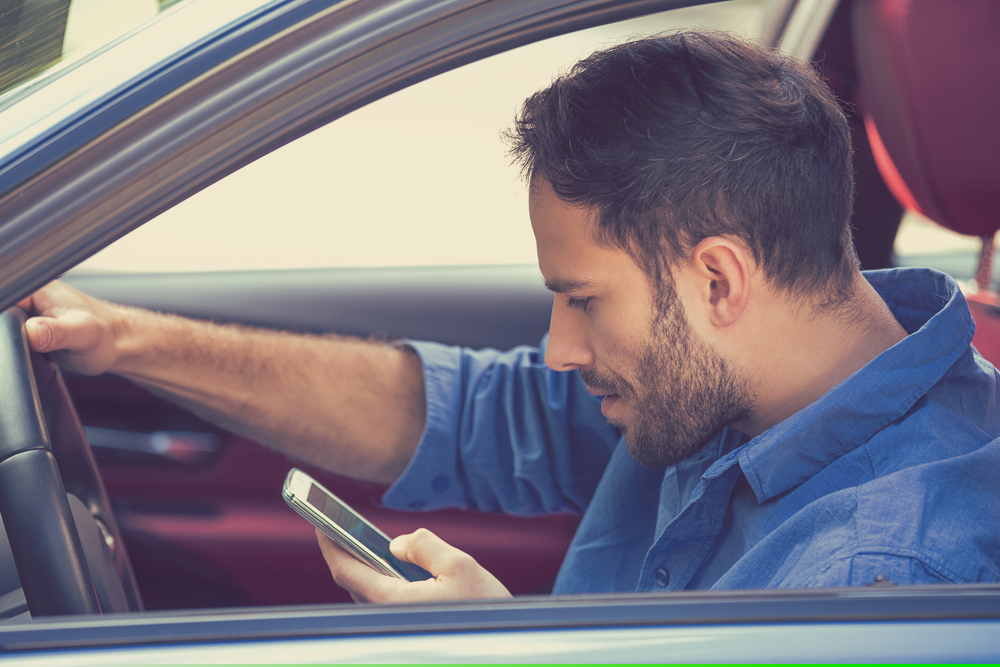 Portrait,Of,Handsome,Young,Business,Man,Using,Texting,On,Mobile Rowlett Distracted Driving Accident Lawyer